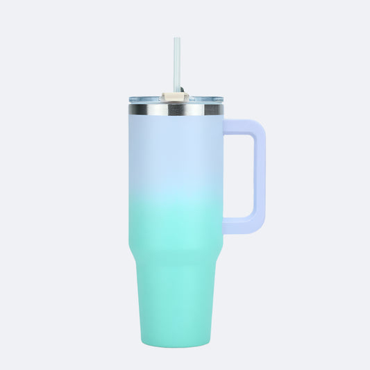 A light green stainless steel tumbler with a straw lid and a handle.