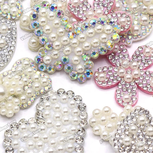 Decorative flowers with pearls and rhinestones on a white background